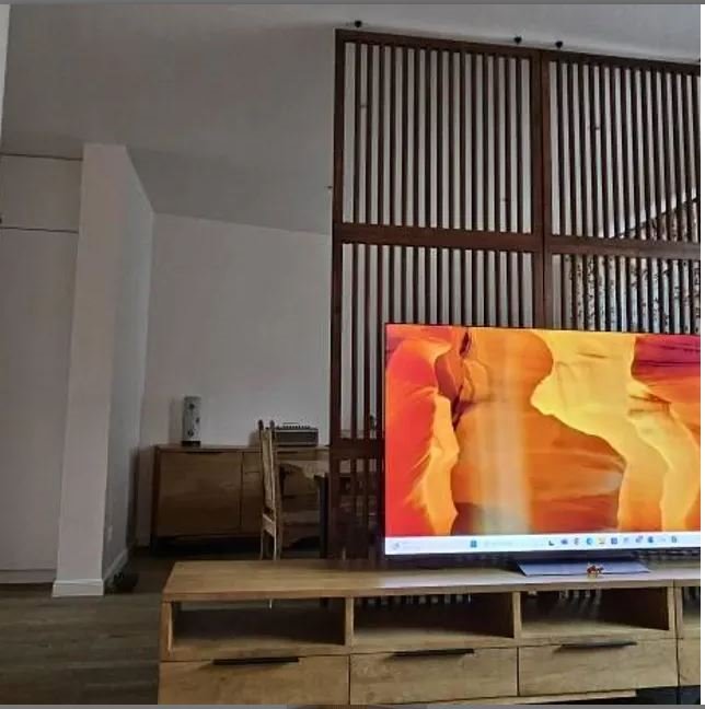 custom wooden room divider separating living room and home office