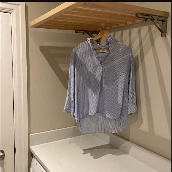 wooden wall-mounted foldable drying rack in laundry room