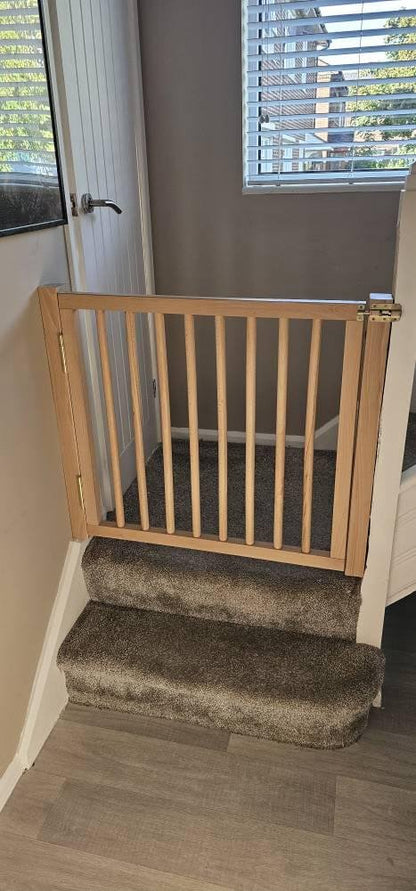wooden stair divider gate protecting toddlers and pets