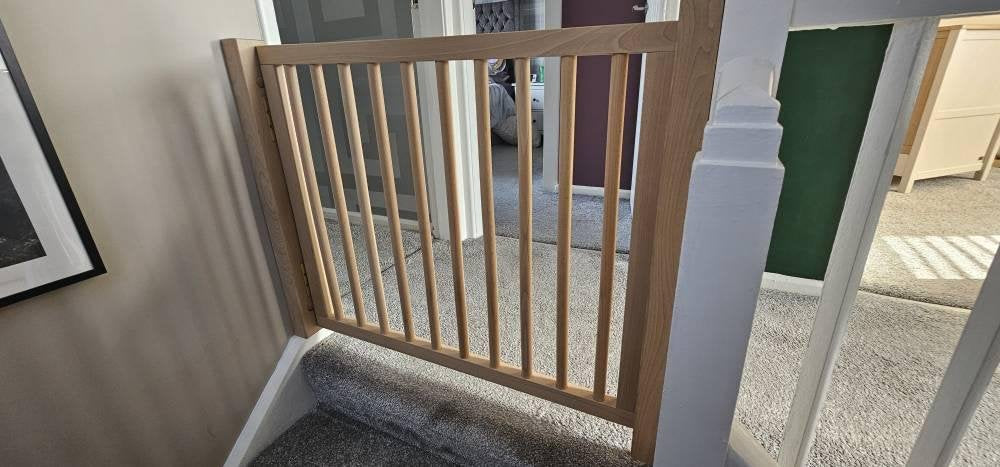 handcrafted wooden child safety gate in modern living room